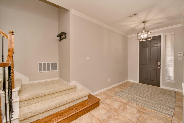 foyer featuring crown molding, an inviting chandelier, and light tile patterned floors