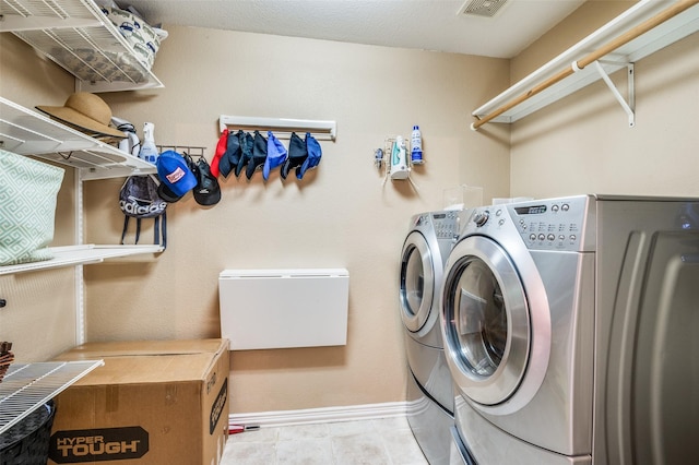 clothes washing area with washer and clothes dryer