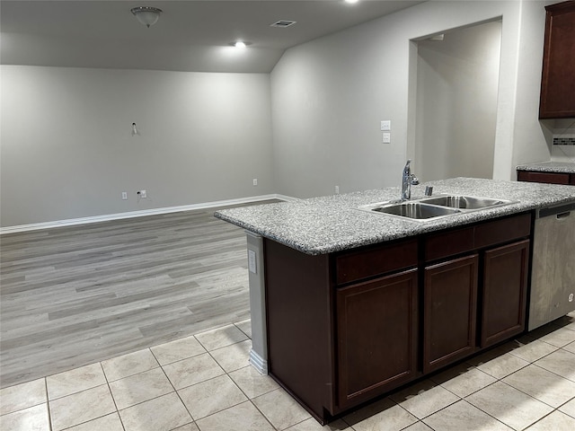 kitchen with light tile patterned flooring, a sink, visible vents, stainless steel dishwasher, and a center island with sink