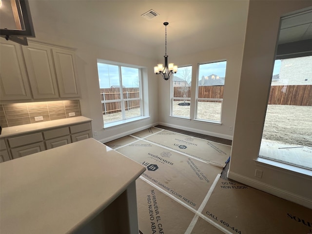 unfurnished dining area with a notable chandelier