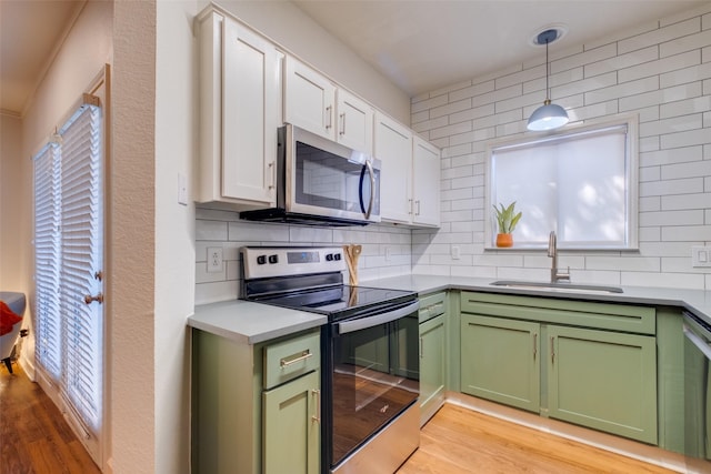 kitchen with white cabinetry, appliances with stainless steel finishes, and sink