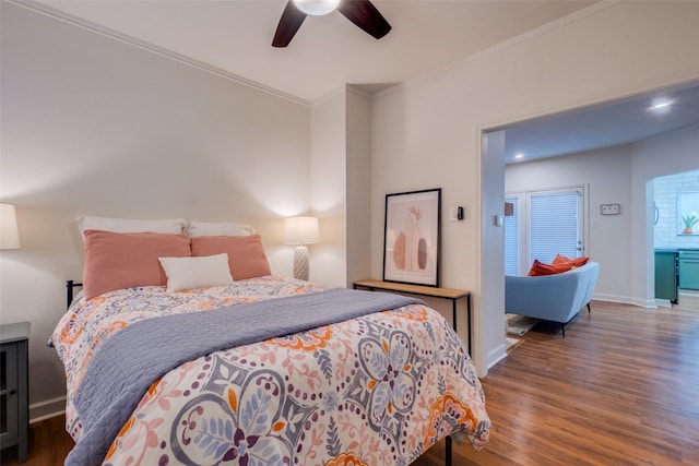 bedroom featuring crown molding, dark hardwood / wood-style flooring, and ceiling fan