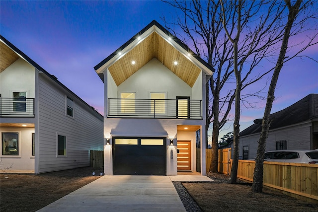 contemporary house featuring a garage and a balcony