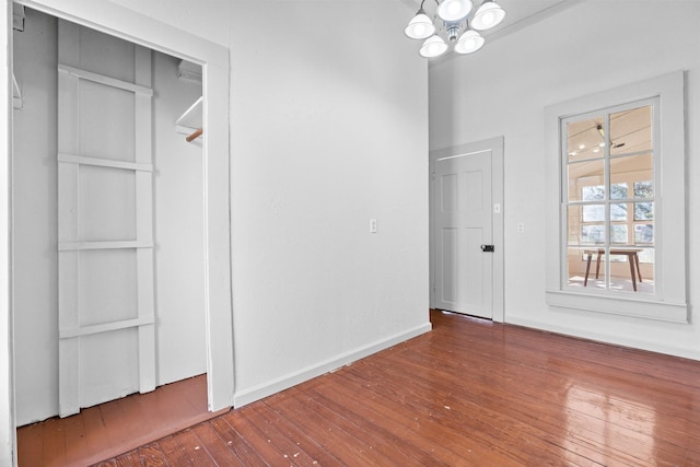 unfurnished dining area featuring hardwood / wood-style floors and an inviting chandelier