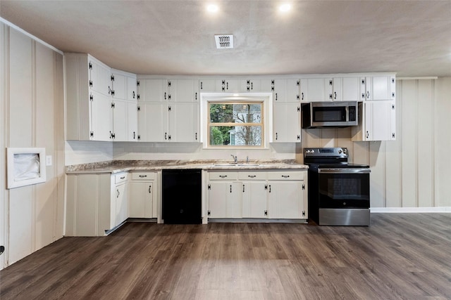 kitchen with stainless steel appliances, white cabinetry, visible vents, and dark wood-type flooring