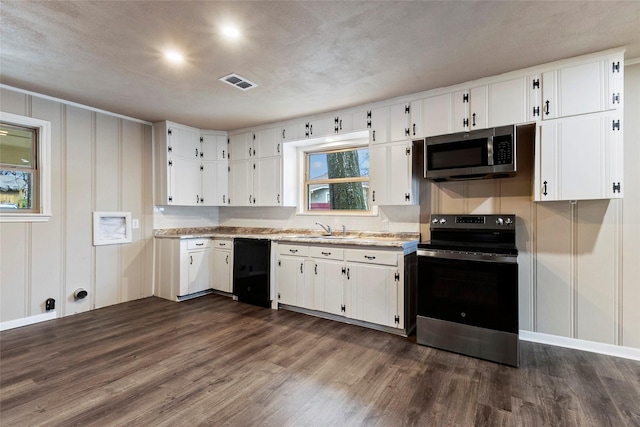 kitchen featuring appliances with stainless steel finishes, white cabinets, dark wood finished floors, and visible vents