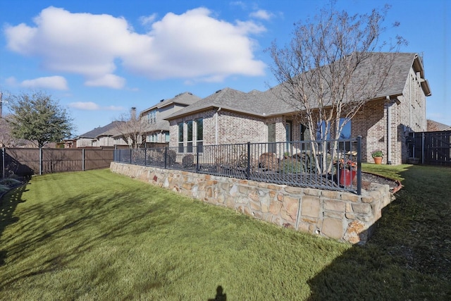 view of yard with a fenced backyard