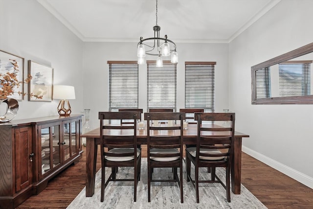 dining space featuring dark wood-style floors, plenty of natural light, baseboards, and a notable chandelier