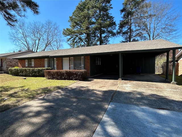 single story home featuring a front yard and a carport