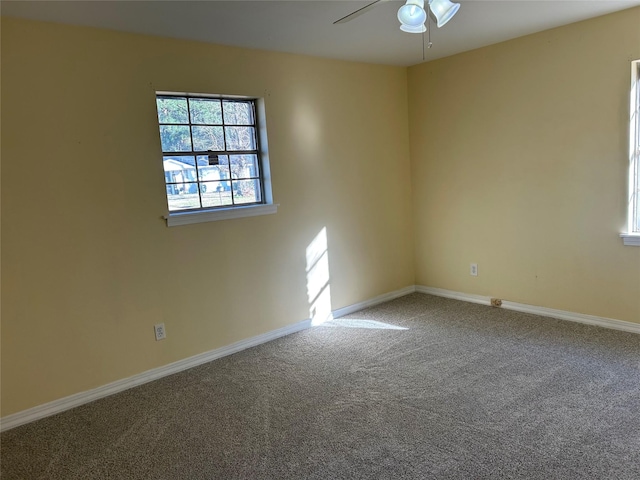 unfurnished room with ceiling fan and carpet flooring