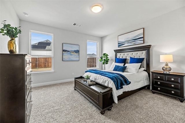 bedroom with visible vents, baseboards, and light colored carpet