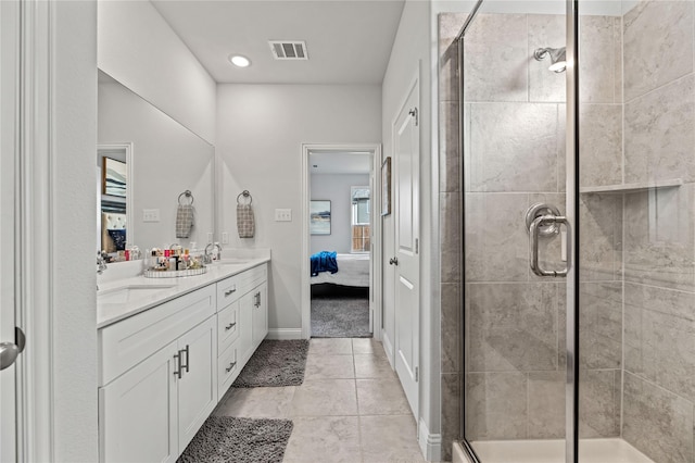 bathroom featuring tile patterned flooring, vanity, and walk in shower