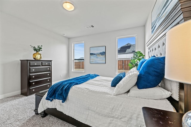 bedroom with carpet floors, baseboards, and visible vents