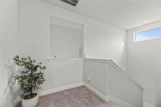 unfurnished room featuring visible vents, baseboards, and carpet floors