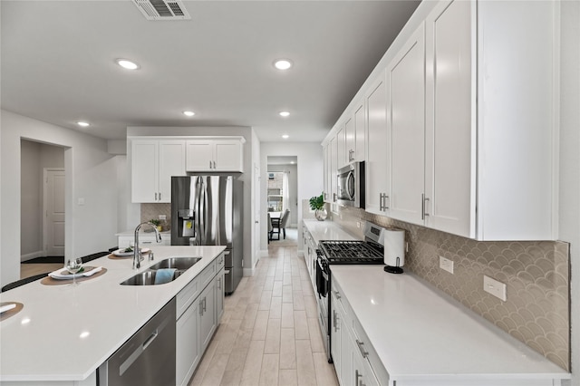 kitchen with visible vents, a sink, recessed lighting, and stainless steel appliances
