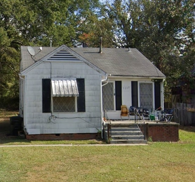 bungalow-style home with a front lawn