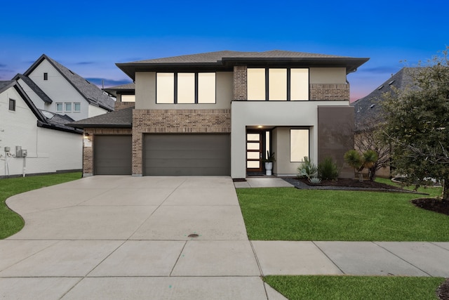 view of front of house featuring a garage and a yard