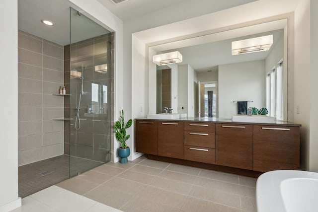4112 Heatherton Dr, Celina, TX 75009 - bathroom with walk in shower, double vanity, tile patterned floors, recessed lighting, and a soaking tub
