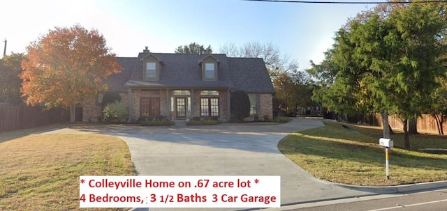 view of front of house featuring fence, a front lawn, concrete driveway, and french doors