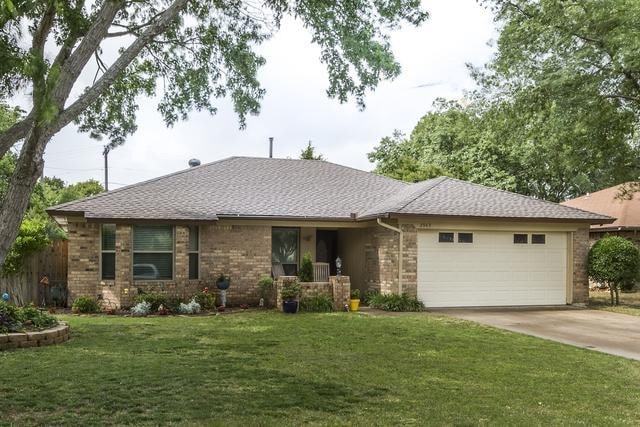 ranch-style home featuring a garage and a front yard