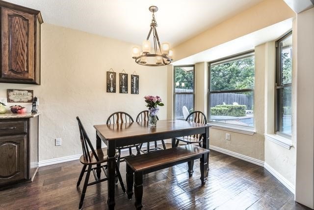 dining area featuring a chandelier and dark hardwood / wood-style floors