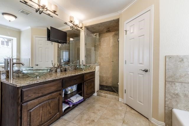 bathroom featuring ornamental molding, vanity, tile patterned flooring, and a shower with shower door