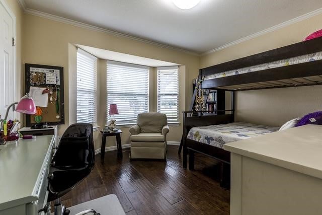 bedroom with ornamental molding and dark wood-type flooring