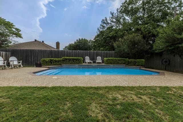 view of pool with a yard and a patio area