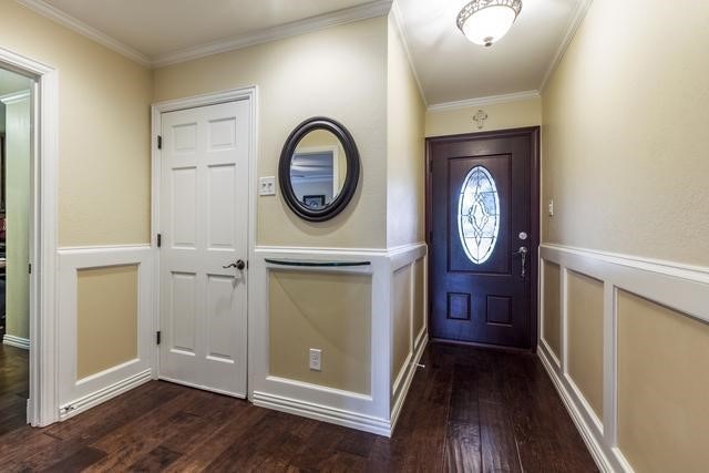 entryway with crown molding and dark hardwood / wood-style flooring