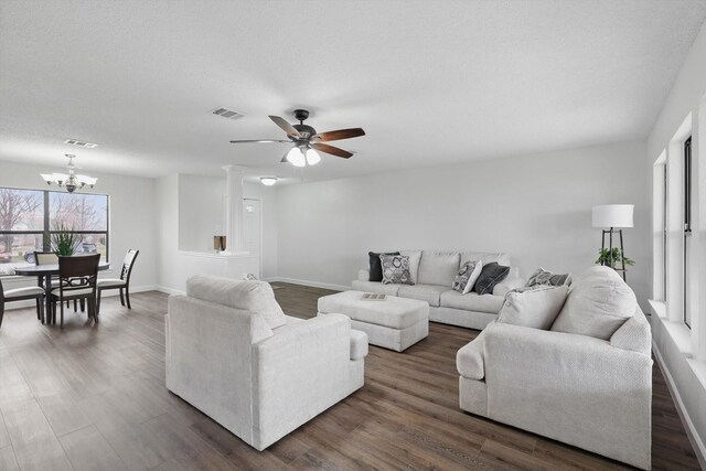2160 Glenhaven Dr, Lewisville, TX 75067 - living room featuring a ceiling fan, dark wood-type flooring, and a chandelier