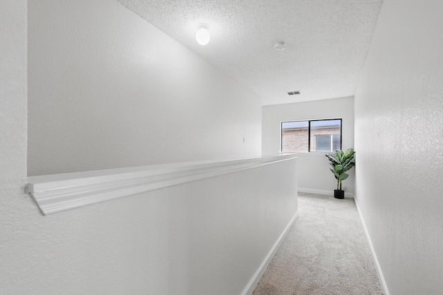 2160 Glenhaven Dr, Lewisville, TX 75067 - corridor featuring carpet flooring, a textured ceiling, and a textured wall