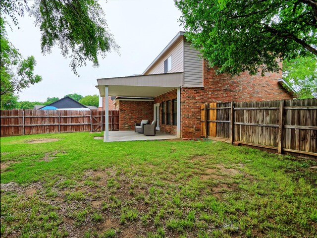 2160 Glenhaven Dr, Lewisville, TX 75067 - rear view of house with a patio area, brick siding, and a fenced backyard