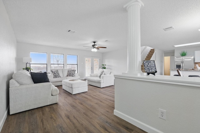 2160 Glenhaven Dr, Lewisville, TX 75067 - living area with ornate columns, ceiling fan, dark wood finished floors, and a textured ceiling
