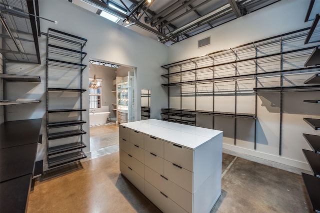 walk in closet with a towering ceiling