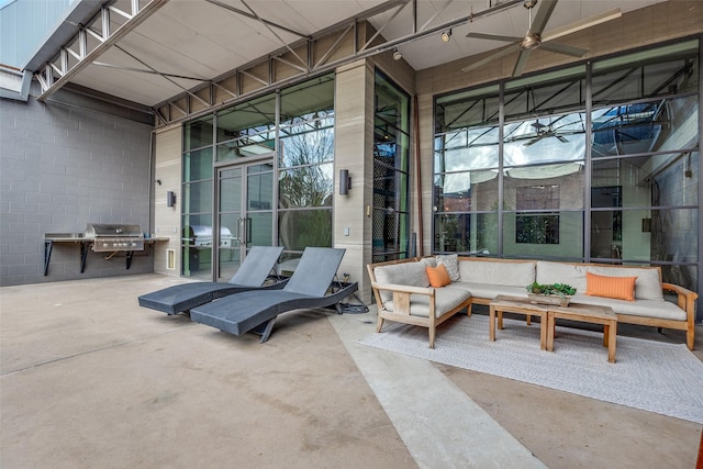 view of patio / terrace with an outdoor living space, area for grilling, and ceiling fan