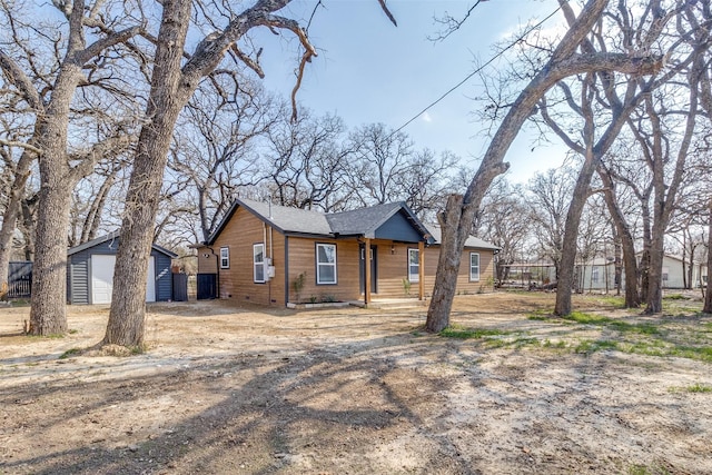 view of front of house with a garage and an outdoor structure