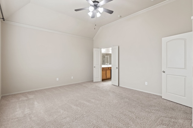 unfurnished bedroom featuring light carpet, baseboards, lofted ceiling, and crown molding