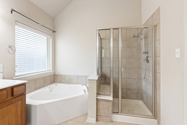 full bath featuring a garden tub, lofted ceiling, a stall shower, vanity, and tile patterned flooring