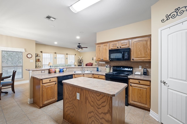 kitchen with a center island, sink, kitchen peninsula, and black appliances