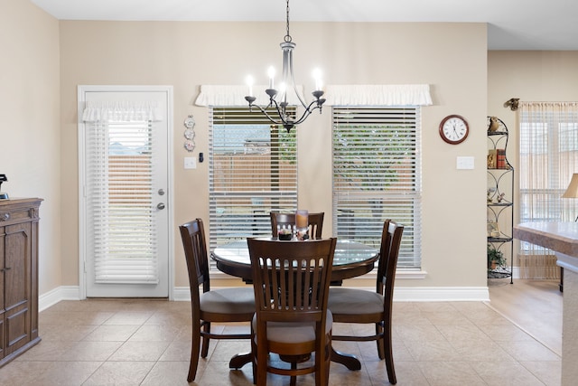 tiled dining area with a notable chandelier and a wealth of natural light