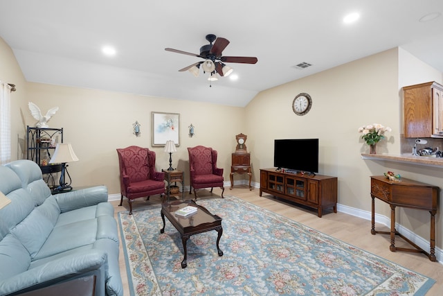 living room with vaulted ceiling, ceiling fan, and light hardwood / wood-style flooring