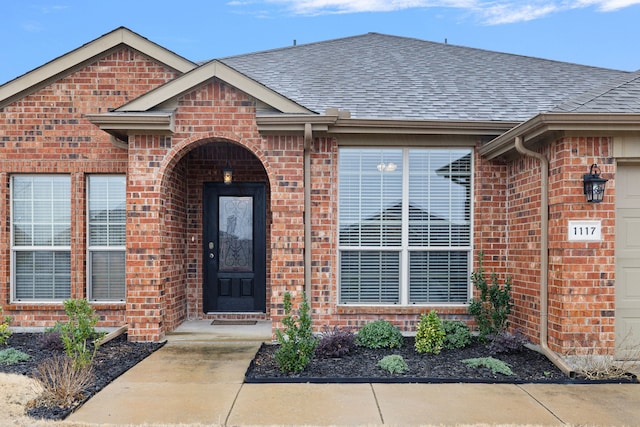 view of exterior entry with a garage