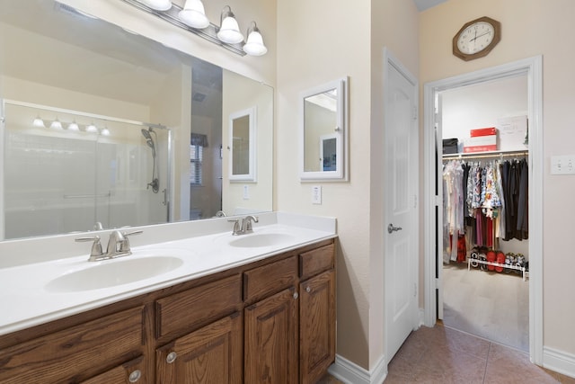bathroom featuring vanity, tile patterned floors, and walk in shower