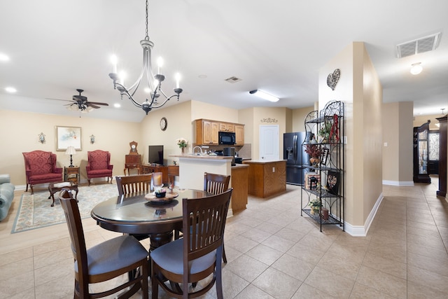 tiled dining area with ceiling fan with notable chandelier