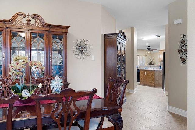 tiled dining area featuring ceiling fan