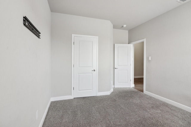 unfurnished bedroom featuring dark colored carpet