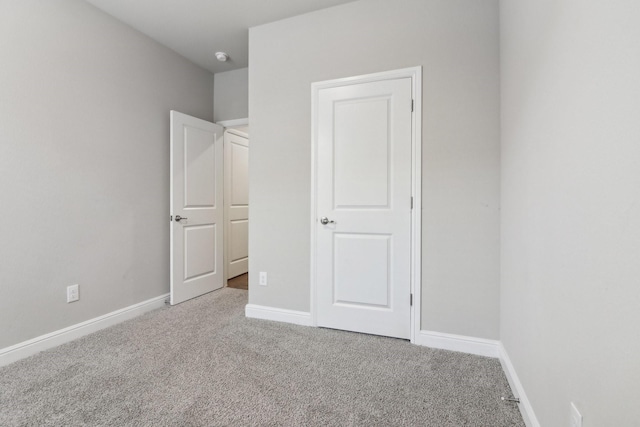 unfurnished bedroom featuring light colored carpet