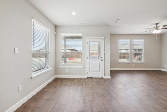 unfurnished room featuring dark hardwood / wood-style floors and ceiling fan