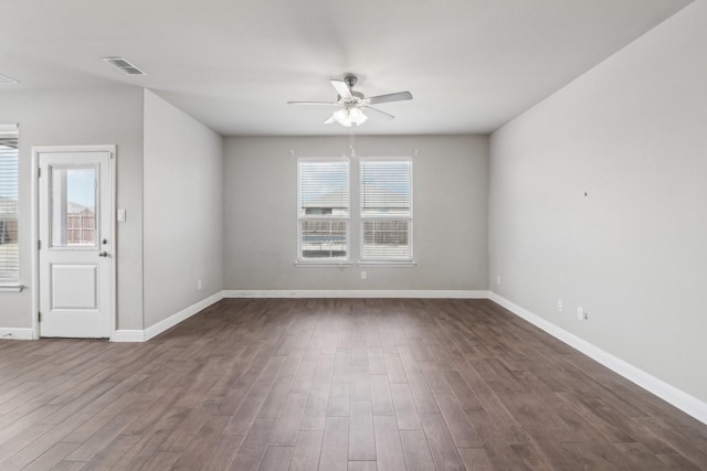 unfurnished room featuring dark wood-type flooring and ceiling fan