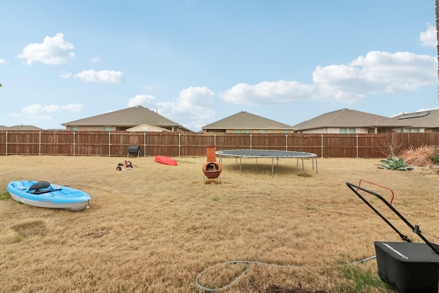 view of playground with a lawn and a trampoline